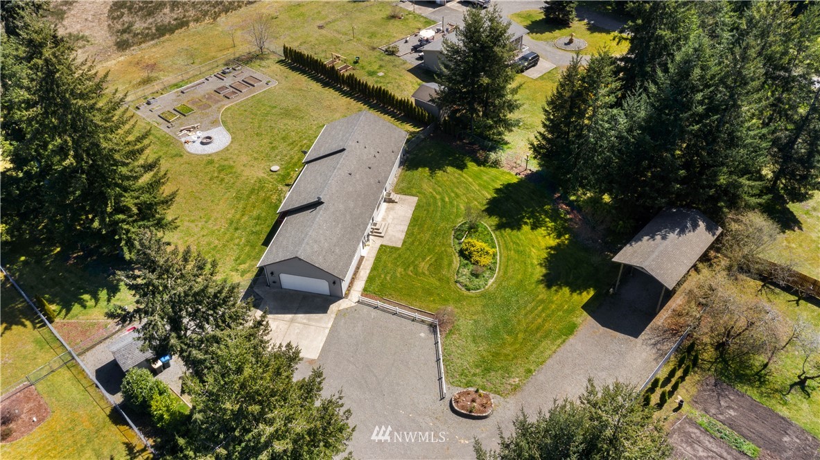 18926 Nutmeg Street Southwest Rochester, WA 98579 - Photo 3 of 23 an aerial view of a house with a yard and swimming pool