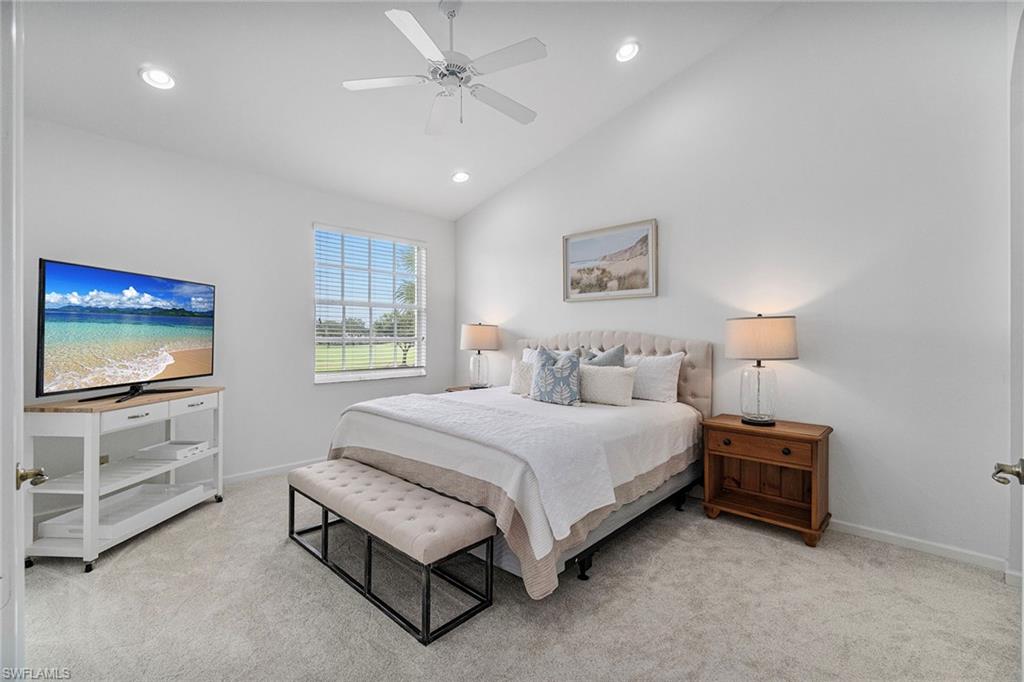 23081 Rosedale Drive, Unit 201 Estero, FL 34135 - Photo 6 of 18 a spacious bedroom with a bed and a flat screen tv