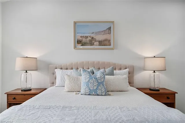 a bedroom with a bed and a lamp