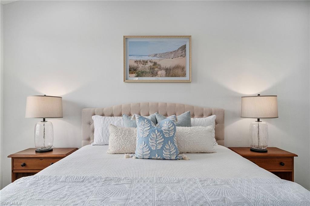 23081 Rosedale Drive, Unit 201 Estero, FL 34135 - Photo 7 of 18 a bedroom with a bed and a lamp