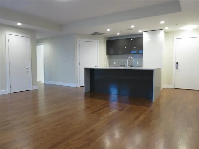 a view of a kitchen with a sink and a fireplace