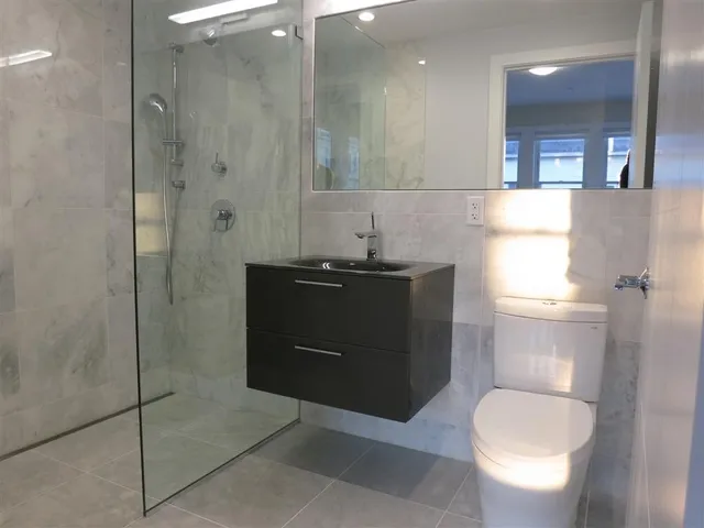 a bathroom with a toilet a sink and shower