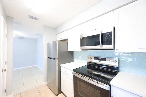 a kitchen with a sink and a mirror