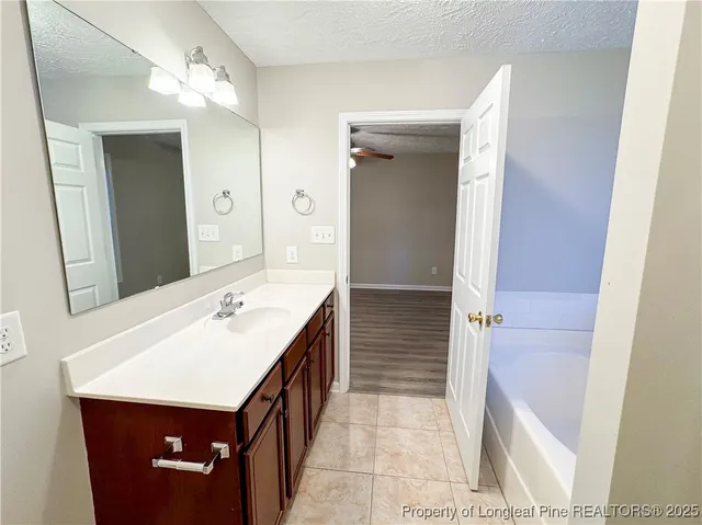 a bathroom with a sink a mirror and a shower