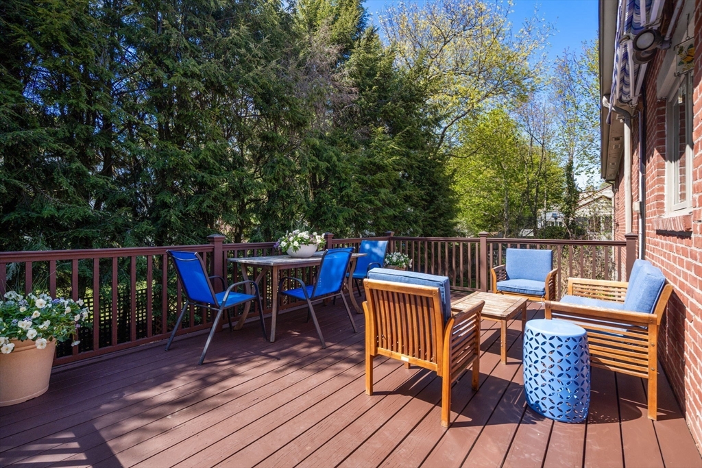 50 Mary Ellen Road Newton, MA 02468 - Photo 18 of 22 a view of deck with table and chairs potted plants and wooden floor