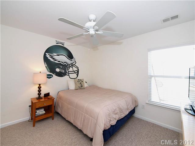 150 Whitley Mills Road Fort Mill, SC 29708 - Photo 11 of 16 a bedroom with a bed and a chandelier