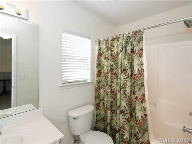 150 Whitley Mills Road Fort Mill, SC 29708 - Photo 12 of 16 a white toilet sitting next to a shower curtain