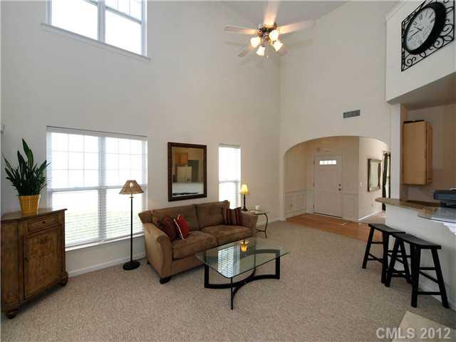 150 Whitley Mills Road Fort Mill, SC 29708 - Photo 4 of 16 a living room with furniture a chandelier and a window