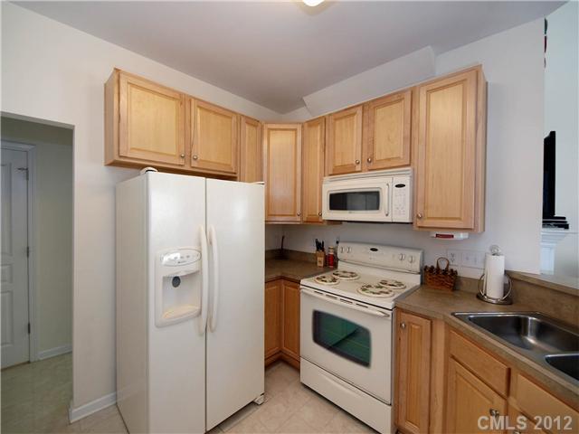 150 Whitley Mills Road Fort Mill, SC 29708 - Photo 5 of 16 a kitchen with white cabinets and white appliances