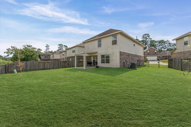 a view of a house with a yard and sitting area