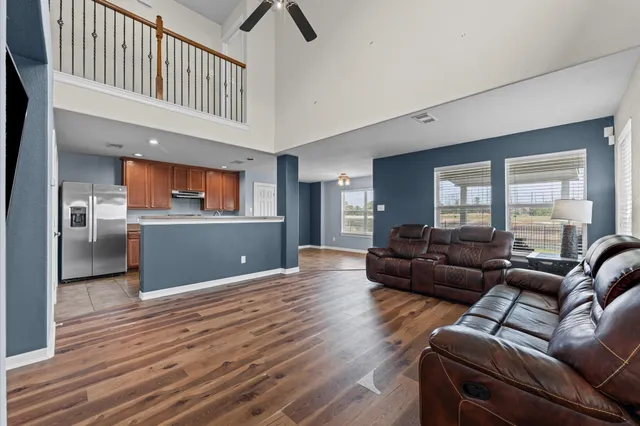 a living room with furniture and a kitchen