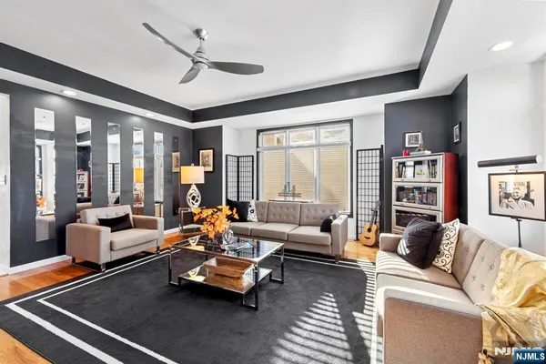 a living room with furniture and a large window