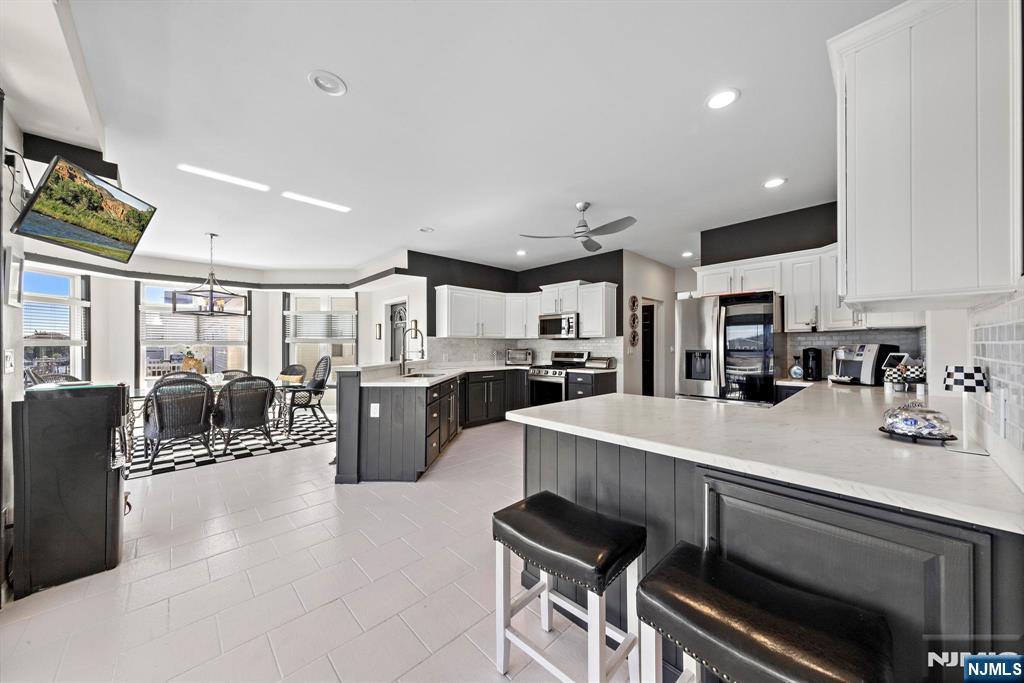 19 Maryland Road Little Egg Harbor, NJ 08087 - Photo 18 of 48 a large white kitchen with lots of counter space dining table and chairs
