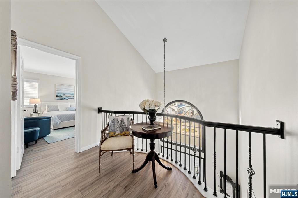 19 Maryland Road Little Egg Harbor, NJ 08087 - Photo 26 of 48 a view of a hallway with a dining table chairs with wooden floor and a chandelier