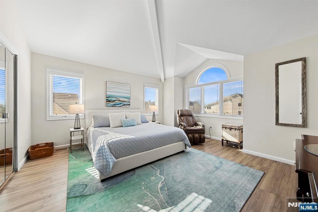 19 Maryland Road Little Egg Harbor, NJ 08087 - Photo 28 of 48 a spacious bedroom with a bed a table and large windows