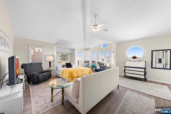 a living room with furniture a chandelier and a flat screen tv