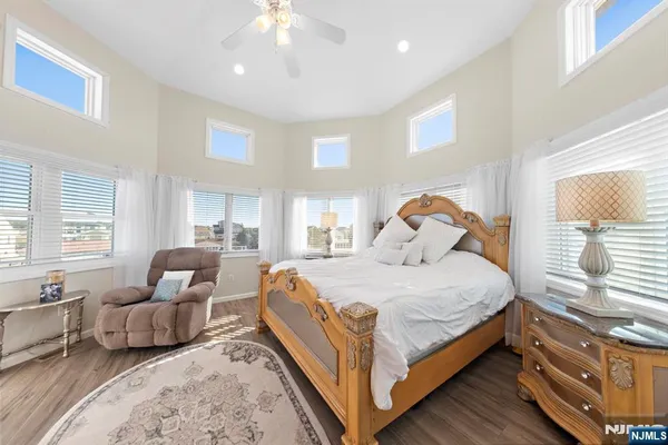 a bedroom with a bed couch and window