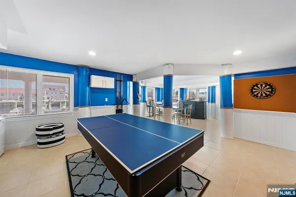 a room with furniture pool table and windows