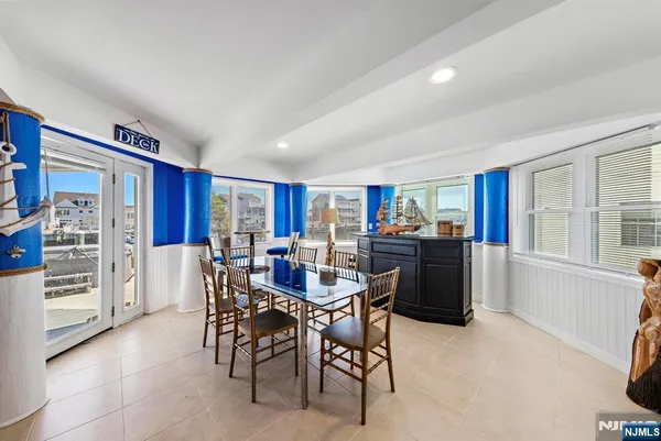 a view of a dining room with furniture and a window