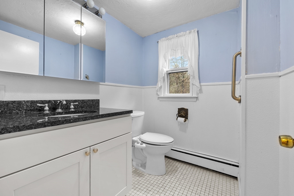 58 Lakeview Road Foxboro, MA 02035 - Photo 21 of 42 a kitchen with a sink a toilet and cabinets
