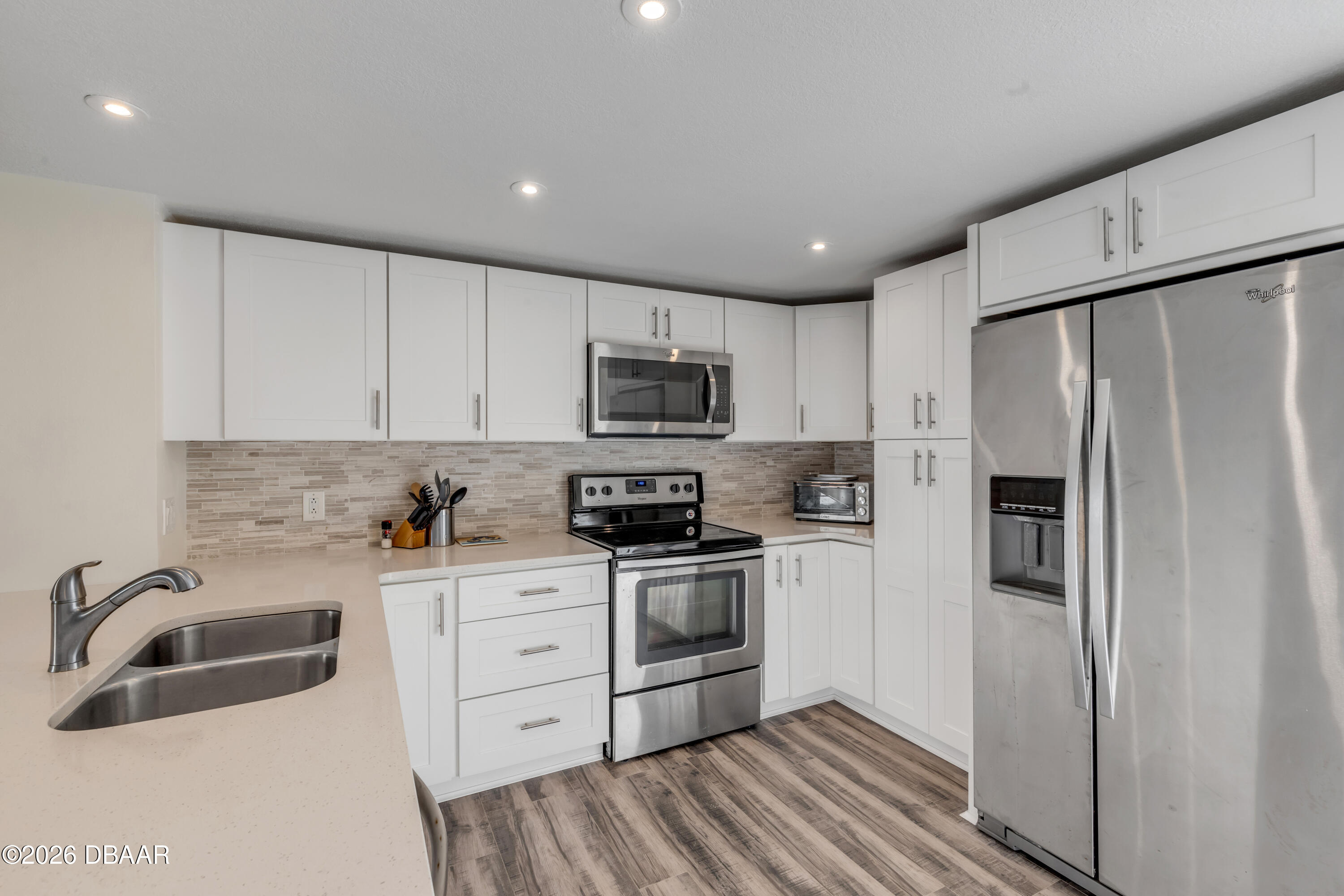 4752 South Atlantic Avenue, Unit 1 Ponce Inlet, FL 32127 - Photo 13 of 49 a kitchen with stainless steel appliances a refrigerator sink and microwave