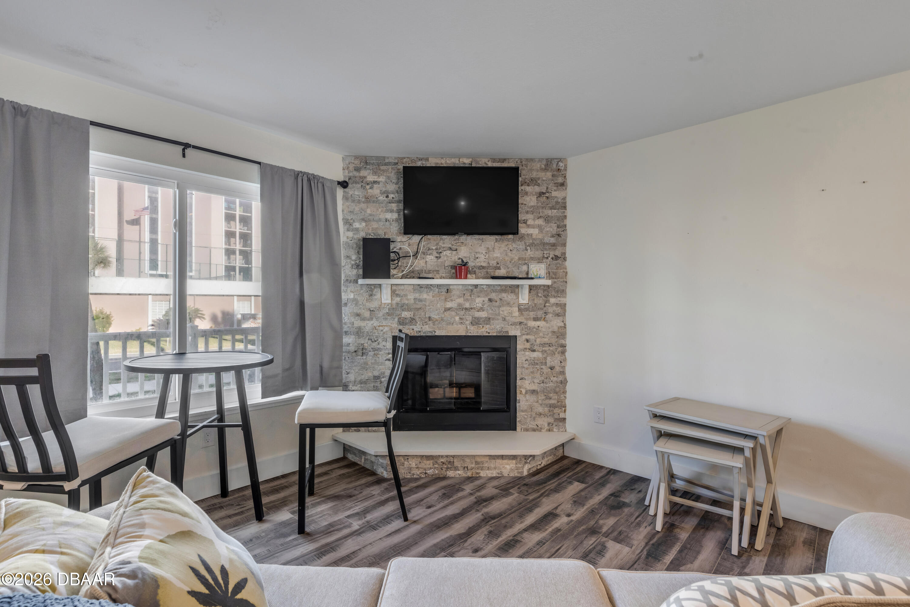 4752 South Atlantic Avenue, Unit 1 Ponce Inlet, FL 32127 - Photo 20 of 49 a living room with furniture and a fireplace