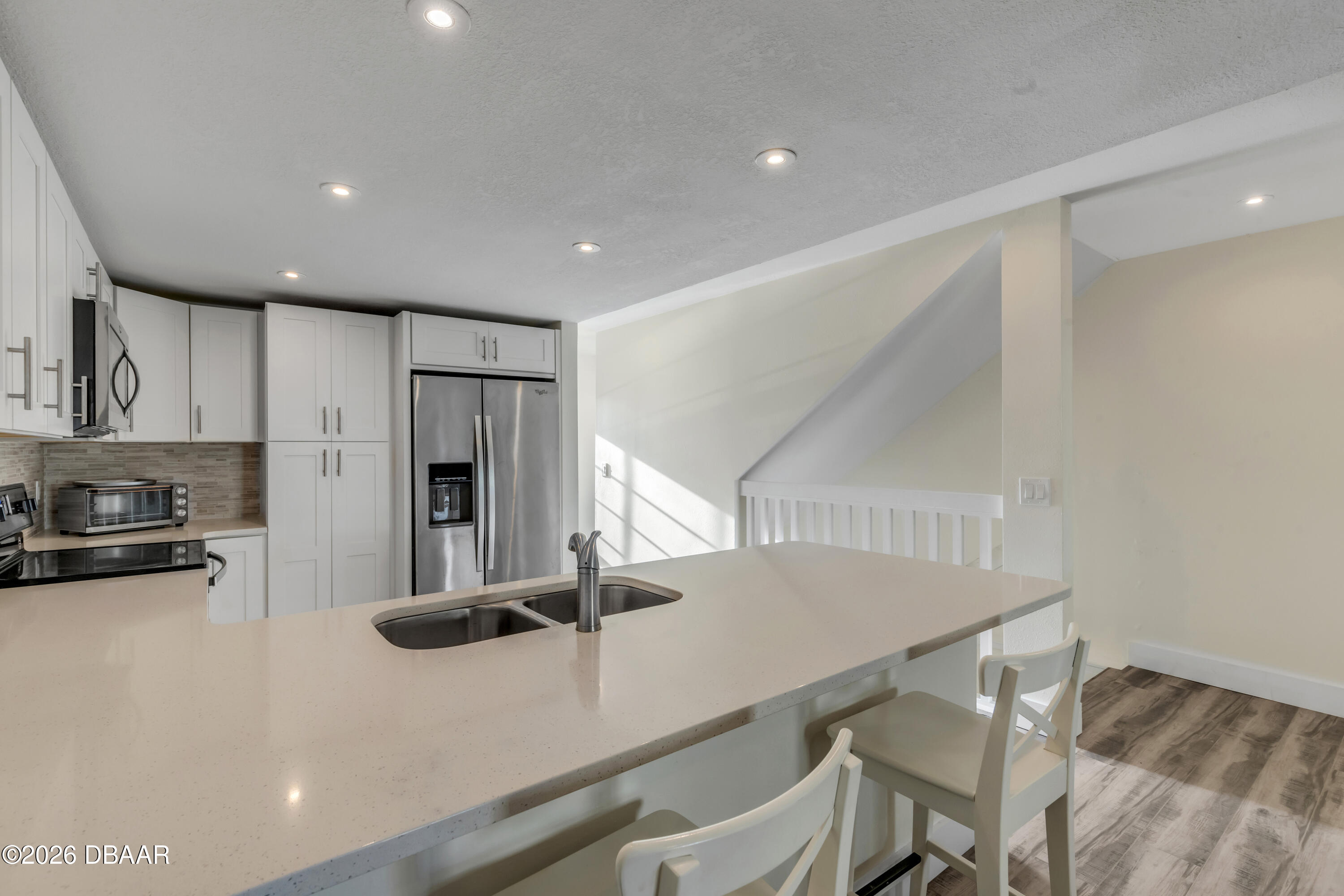 4752 South Atlantic Avenue, Unit 1 Ponce Inlet, FL 32127 - Photo 2 of 49 a kitchen with stainless steel appliances a refrigerator sink and stove