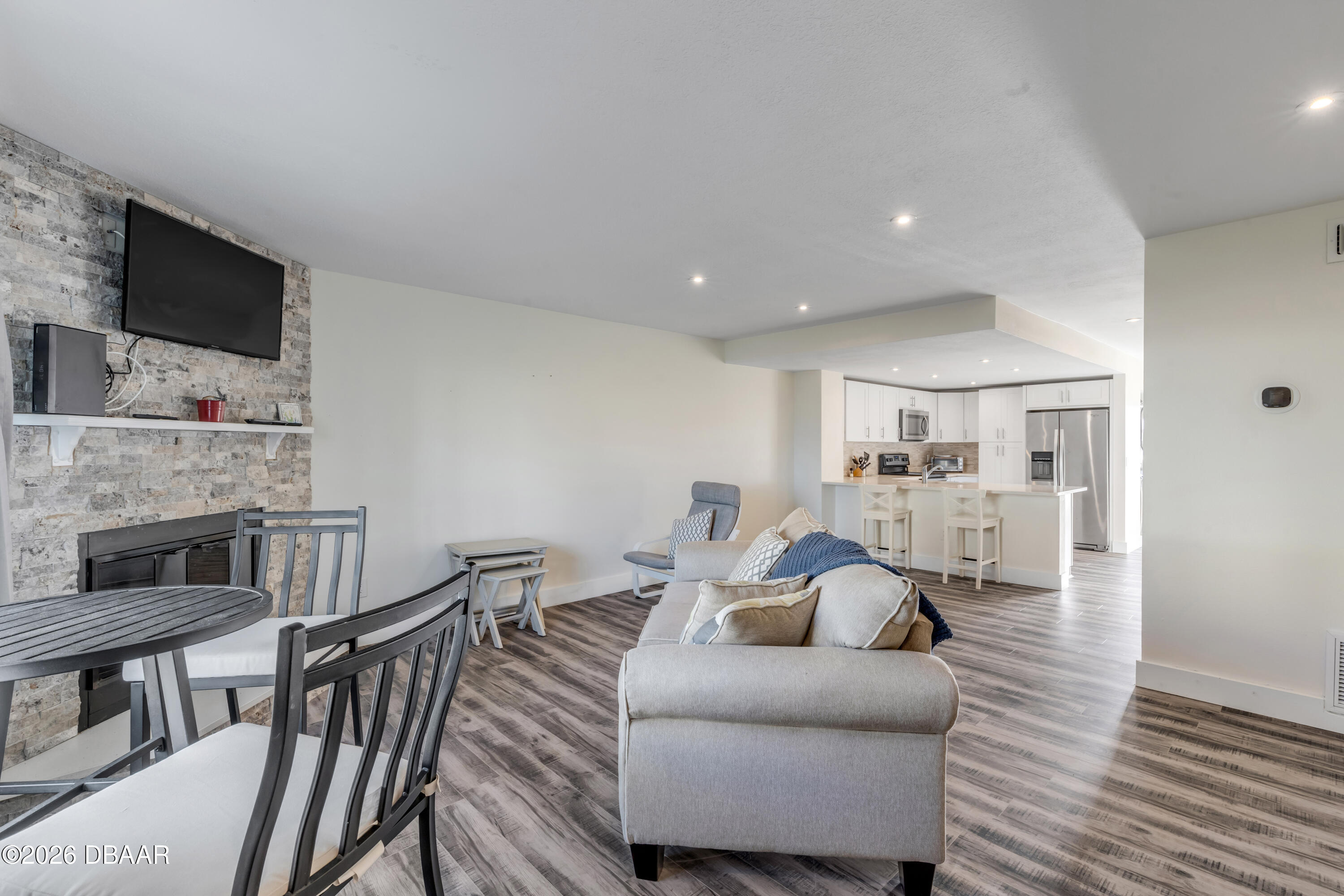 4752 South Atlantic Avenue, Unit 1 Ponce Inlet, FL 32127 - Photo 22 of 49 a living room with furniture and a flat screen tv