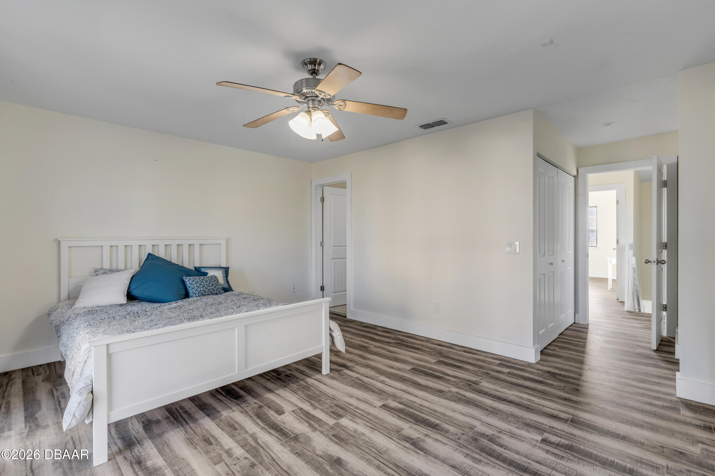 4752 South Atlantic Avenue, Unit 1 Ponce Inlet, FL 32127 - Photo 32 of 49 a bedroom with furniture and wooden floor