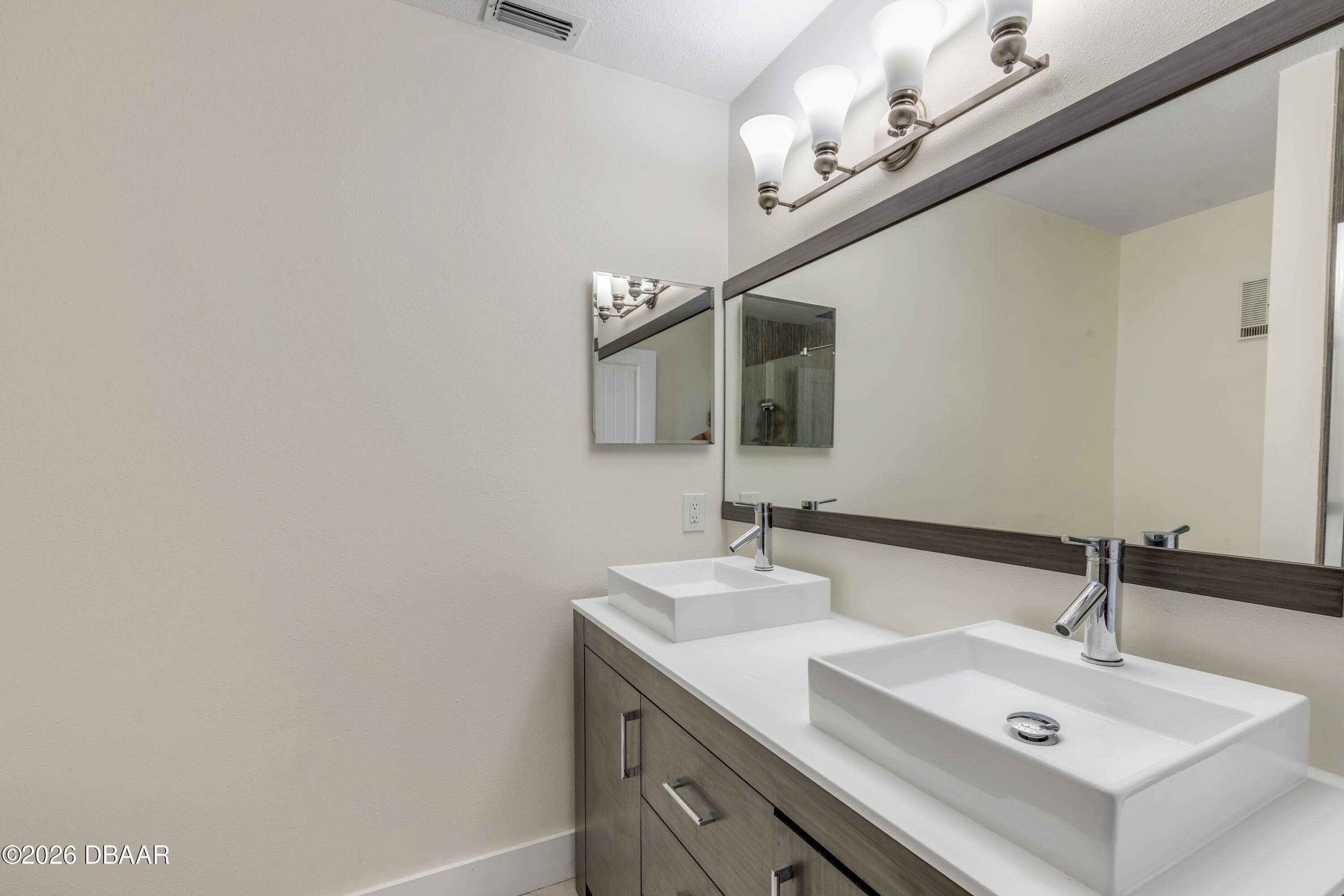 4752 South Atlantic Avenue, Unit 1 Ponce Inlet, FL 32127 - Photo 34 of 49 a bathroom with a sink and a mirror