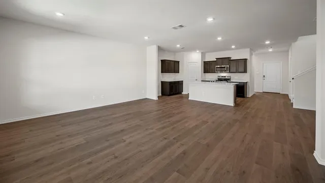 a view of kitchen with refrigerator microwave and stove