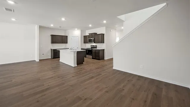 a view of a hallway with wooden floor and entryway