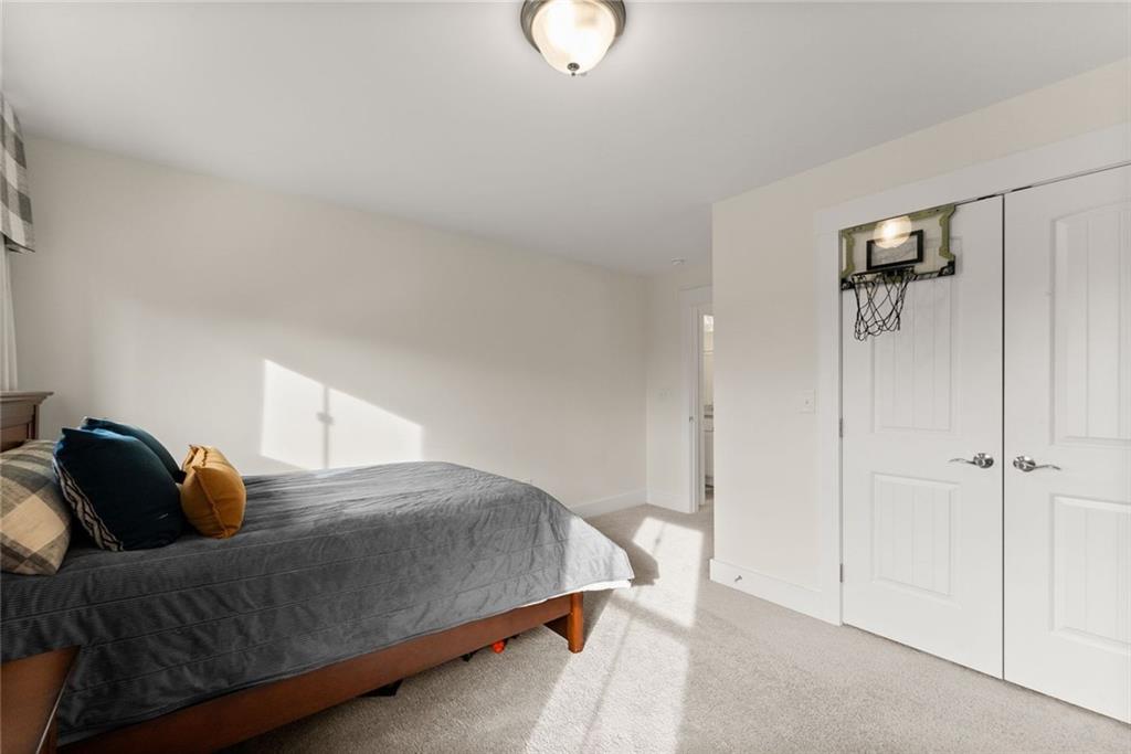 6998 Britt Gailey Road Clermont, GA 30527 - Photo 55 of 92 a bedroom with a bed and a lamp
