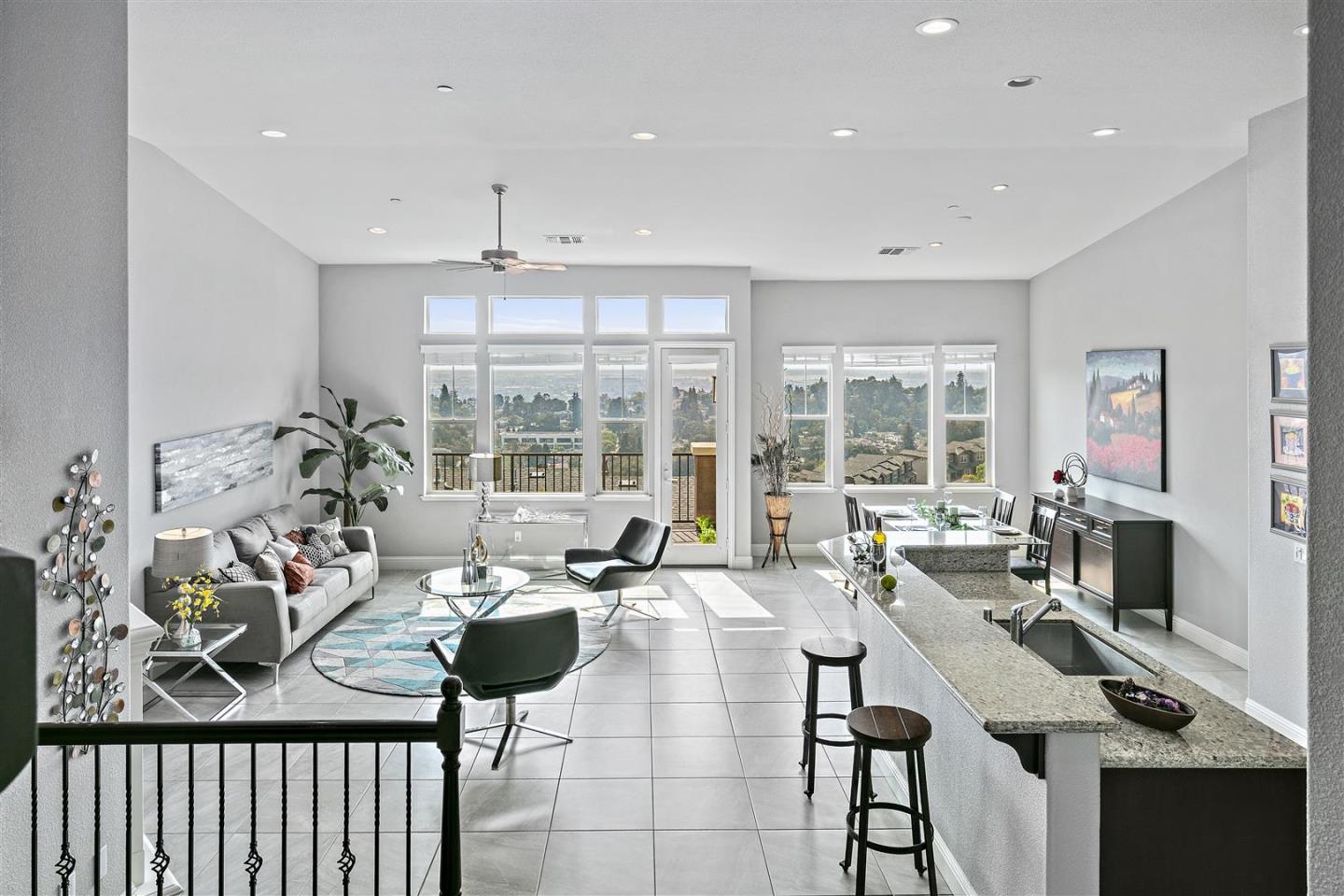 a living room with fireplace furniture and a large window