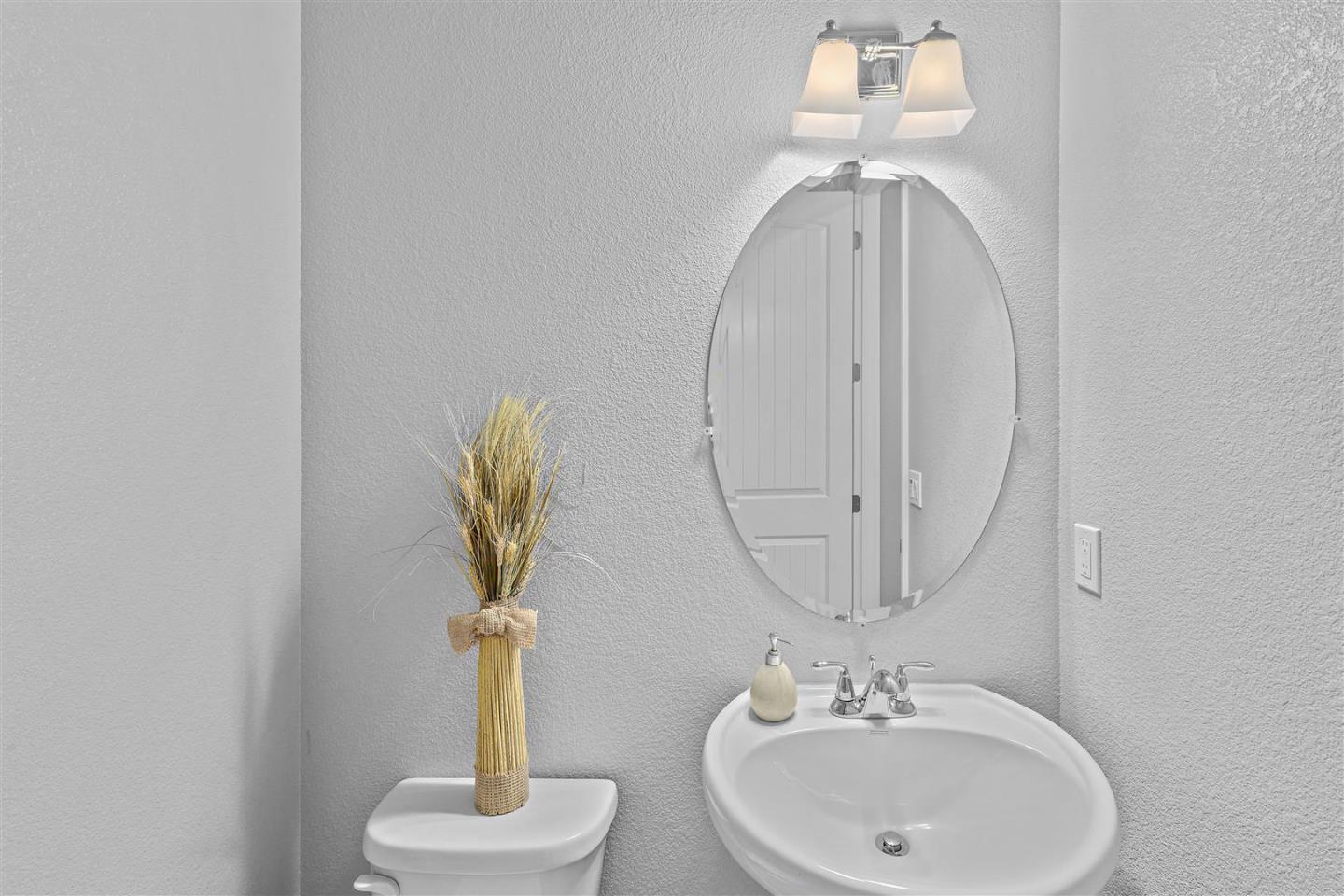 Oakland, 94605 - Photo 30 of 61 a bathroom with a sink a toilet and a mirror