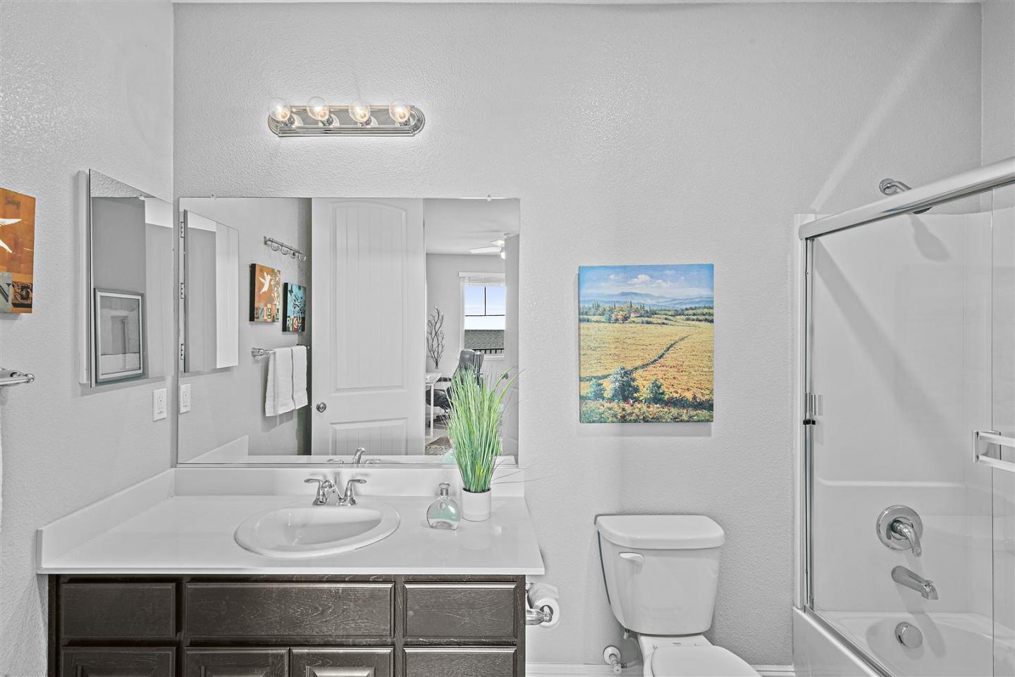 Oakland, 94605 - Photo 50 of 61 a bathroom with a granite countertop sink a toilet and shower