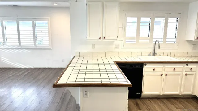 a view of a kitchen with a sink and wooden floor