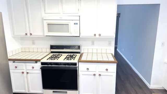 a kitchen with a stove and a microwave