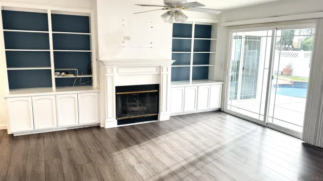 a view of a livingroom with an empty space and a fireplace