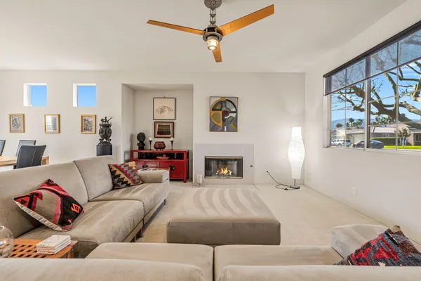 a living room with furniture fireplace and window