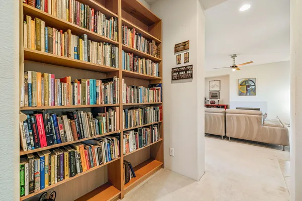 a living room with furniture and a book shelf