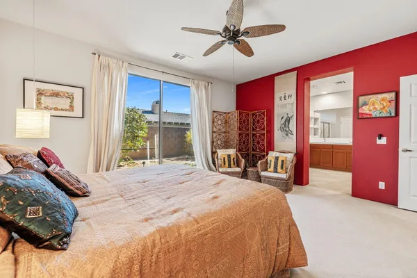 a bedroom with a bed and ceiling fan