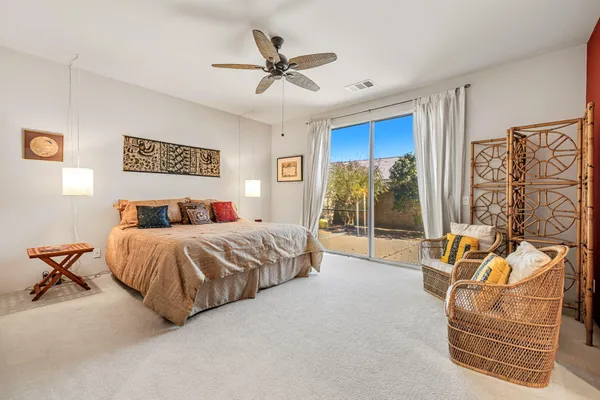 a spacious bathroom with a sink double vanity granite and a mirror