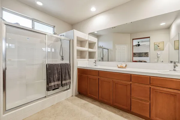 a bedroom with a bed and a potted plant