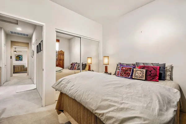 a bedroom with a bed and a desk