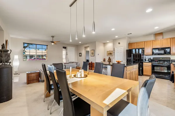 a large kitchen with a table and chairs