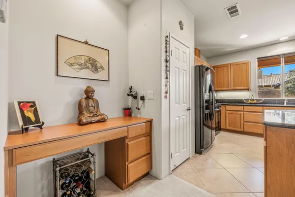 a kitchen with a refrigerator and cabinets