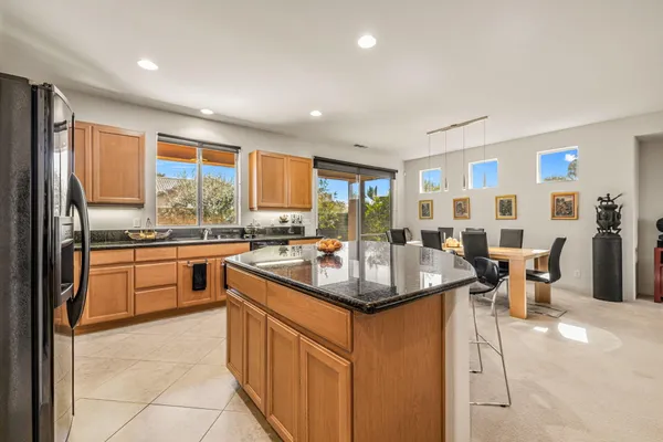 a kitchen with stainless steel appliances granite countertop sink stove and white cabinets