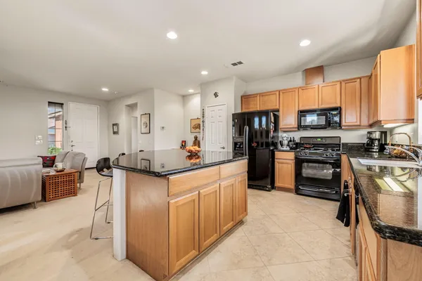 a kitchen with stainless steel appliances a stove sink microwave and cabinets