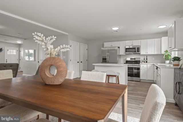 a dining room with furniture and a potted plant